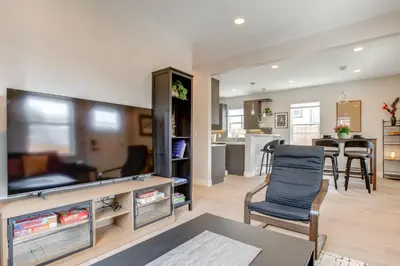 a living room with a flat screen tv and a kitchen at Walk to Med Ctrs and Dtwn Englewood Modern Home in Englewood