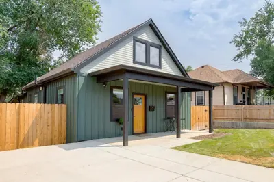 a green house with a black roof at Walk to Med Ctrs and Dtwn Englewood Modern Home in Englewood