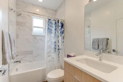 a bathroom with a sink and a tub and a toilet at Walk to Med Ctrs and Dtwn Englewood Modern Home in Englewood