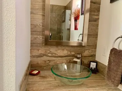 a bathroom with a glass bowl sink on the floor at Spring Gulch Cabin at Base Camp in Dumont