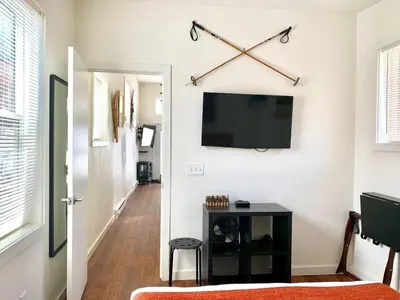 a living room with a flat screen tv on a wall at Iron Horse Cabin at Base Camp Lodging Company in Dumont