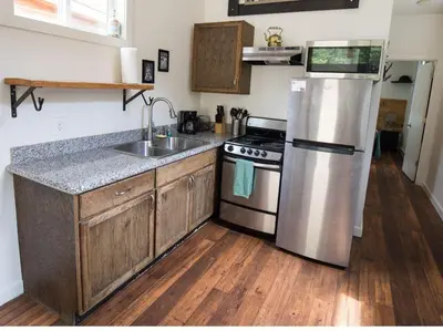 a kitchen with a stainless steel refrigerator and a sink at Iron Horse Cabin at Base Camp Lodging Company in Dumont