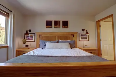 a bedroom with a large bed with a wooden headboard at 122 Lookout Ridge townhouse in Dillon