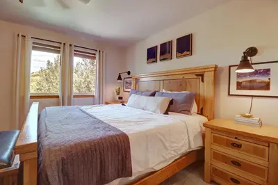 a bedroom with a large bed and a window at 122 Lookout Ridge townhouse in Dillon