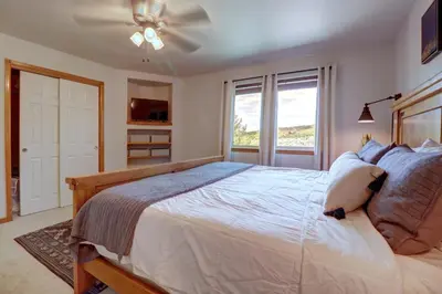 a bedroom with a large bed with a ceiling fan at 122 Lookout Ridge townhouse in Dillon