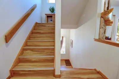 a staircase in a home with white walls and wooden floors at 122 Lookout Ridge townhouse in Dillon