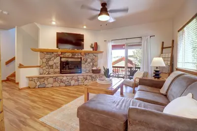 a living room with a couch and a stone fireplace at 122 Lookout Ridge townhouse in Dillon