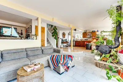 a living room with a couch and a table at Trail Access, Hot Tub Lakefront Boulder Retreat! in Boulder