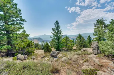 a view from the top of a hill with trees and rocks at Trail Access, Hot Tub Lakefront Boulder Retreat! in Boulder