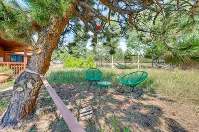 two chairs and a tree with a rope around it at Trail Access, Hot Tub Lakefront Boulder Retreat! in Boulder