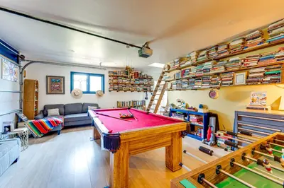 a living room with a pool table and shelves at Trail Access, Hot Tub Lakefront Boulder Retreat! in Boulder