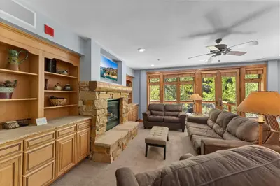 a living room with a couch and a fireplace at Timbers 3074 in Keystone