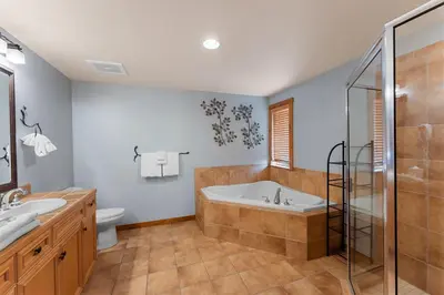 a bathroom with a tub and a sink and a toilet at Timbers 3074 in Keystone