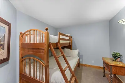 a bedroom with two bunk beds and a desk at Timbers 3074 in Keystone