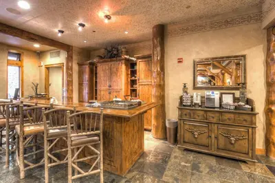 a kitchen with a bar and some wooden cabinets at Timbers 3074 in Keystone