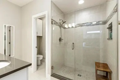 a bathroom with a glass shower with a toilet at Rams Roost with Rooftop Hot Tub, Patio and Family Fun in Fort Collins