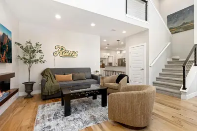 a living room with a couch and a table at Rams Roost with Rooftop Hot Tub, Patio and Family Fun in Fort Collins