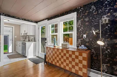 a kitchen with a checkerboard patterned wall at Shade Tree Bungalow in Old Town, Yard & Garage in Fort Collins