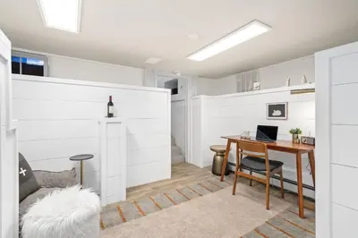 a room with a desk and a bed with a wall at Shade Tree Bungalow in Old Town, Yard & Garage in Fort Collins