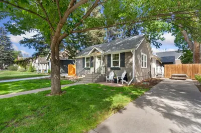 a small house with a tree in the yard at Shade Tree Bungalow in Old Town, Yard & Garage in Fort Collins
