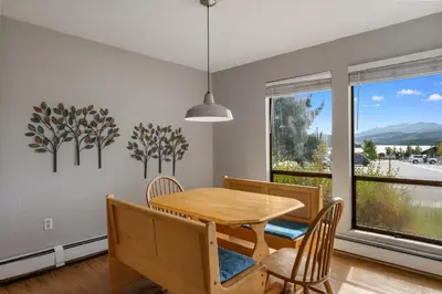 a dining room with a table and chairs and a window at Lake Cliffe 108 Building F in Dillon