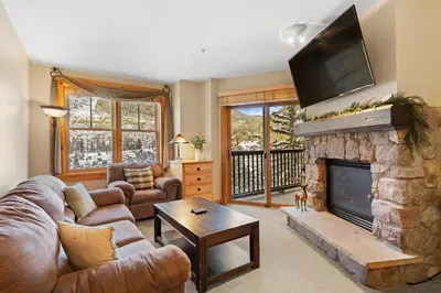 a living room with a couch and a fireplace at Buffalo Lodge 8361 in Keystone