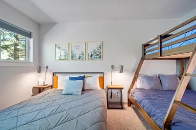 a bedroom with two beds and a bunk bed at Soda Springs Ski Retreat - Heated Pool & Hot Tub in Keystone
