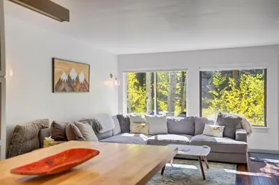a living room with a couch and a table at Soda Springs Ski Retreat - Heated Pool & Hot Tub in Keystone