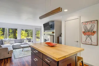 a kitchen with a kitchen island in a living room at Soda Springs Ski Retreat - Heated Pool & Hot Tub in Keystone