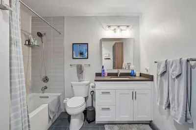 a bathroom with a white toilet and a sink at Soda Springs Ski Retreat - Heated Pool & Hot Tub in Keystone