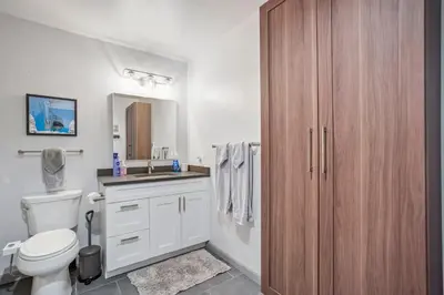 a bathroom with a white toilet and a sink at Soda Springs Ski Retreat - Heated Pool & Hot Tub in Keystone