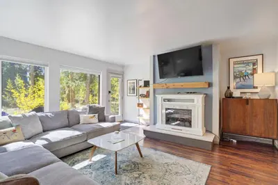 a living room with a couch and a fireplace at Soda Springs Ski Retreat - Heated Pool & Hot Tub in Keystone