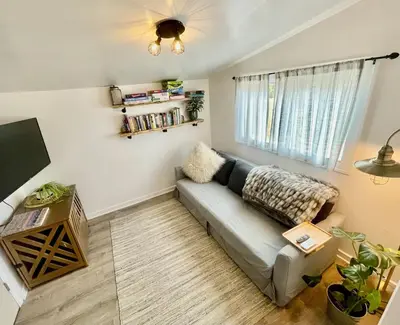 a living room with a couch and a window at Pet Friendly Suite with Fenced Garden, HotTub, Sauna in Denver