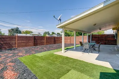 a patio with a table and chairs and a fence at 2 Mi to Hospitals Home with Private Yard in Aurora in Aurora