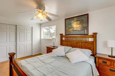 a bedroom with a bed and a ceiling fan at 2 Mi to Hospitals Home with Private Yard in Aurora in Aurora