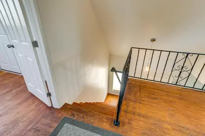 a hallway with a stairway with a stair railing at 2 Mi to Hospitals Home with Private Yard in Aurora in Aurora