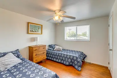 a bedroom with two beds and a ceiling fan at 2 Mi to Hospitals Home with Private Yard in Aurora in Aurora