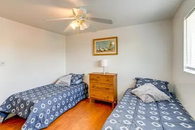 a bedroom with two beds and a ceiling fan at 2 Mi to Hospitals Home with Private Yard in Aurora in Aurora