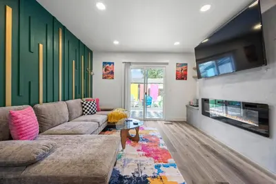 a living room with a couch and a fireplace at Olde Town Gem 5 TVs Hot Tub & Game Yard in Arvada