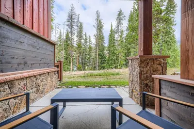 a blue bench sitting on the porch of a house at 1820 The Seasons condo in Keystone