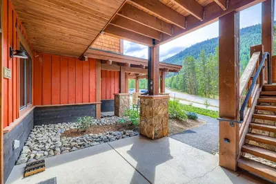 an outside view of a wooden house with a staircase at 1820 The Seasons condo in Keystone