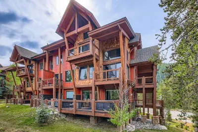 a large wooden house with many windows at 1820 The Seasons condo in Keystone
