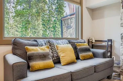 a couch with pillows on it in a living room at 1820 The Seasons condo in Keystone