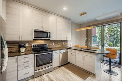 a kitchen with white cabinets and a counter top at 1820 The Seasons condo in Keystone