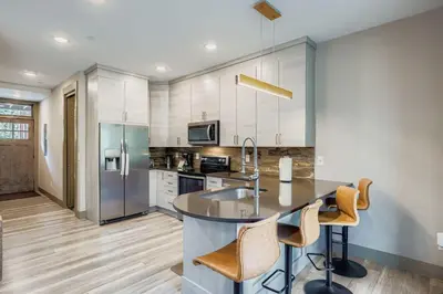 a kitchen with a large island in the middle at 1820 The Seasons condo in Keystone