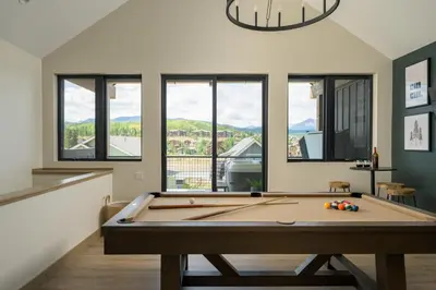 a pool table in a living room with windows at Lodge 212 Brand New LUXE Designer Home and Hot Tub in Fraser