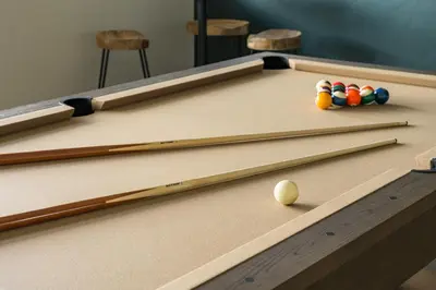 a pool table with a cue ball and cue sticks at Lodge 212 Brand New LUXE Designer Home and Hot Tub in Fraser