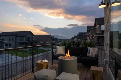 a patio with a fire pit on a balcony at Lodge 212 Brand New LUXE Designer Home and Hot Tub in Fraser