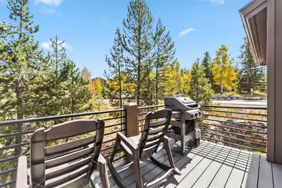 a bbq and two chairs on a deck with a grill at Mountain Getaway Deck Spacious Kitchen in Silverthorne