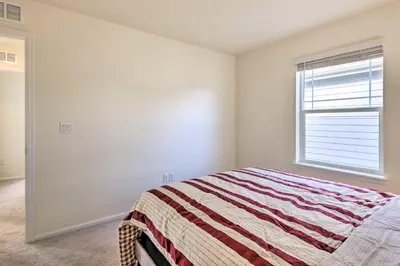 a bedroom with a bed and a window at Charming 3BR Retreat - Perfect for Families in Fort Collins